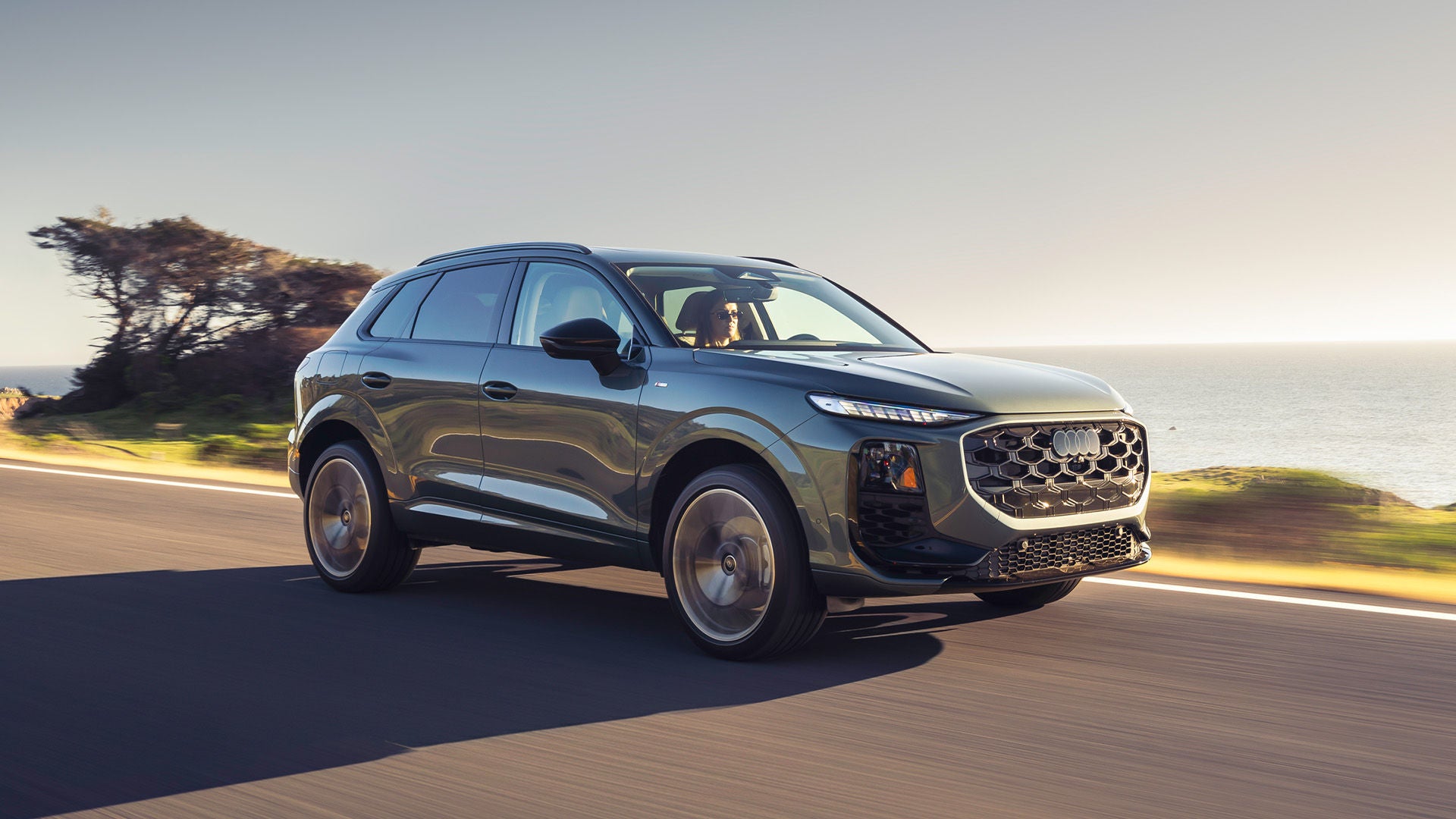 Left profile view of an Audi Q3 accelerating.